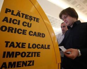 Plata taxelor cu cardul este atractiva pentru romani